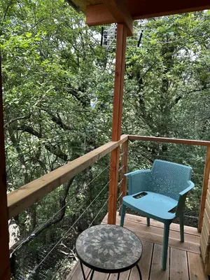 a blue chair and a table on a porch at Mini Apartman - G - Vyhlídka nad řekou in Zámky