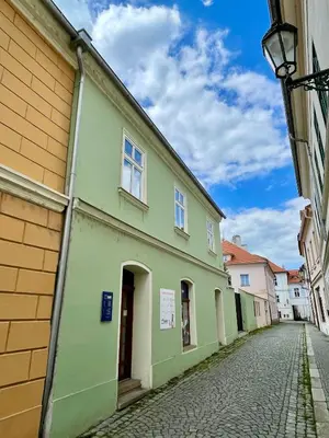 a green building on the side of a street at Apartmán Dominikánská in Litoměřice