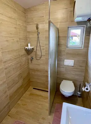 a bathroom with a shower and a toilet and a sink at Apartmán Dominikánská in Litoměřice