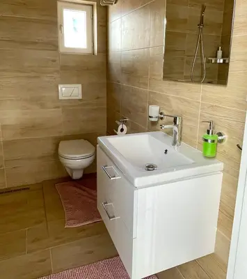 a bathroom with a white sink and a toilet at Apartmán Dominikánská in Litoměřice