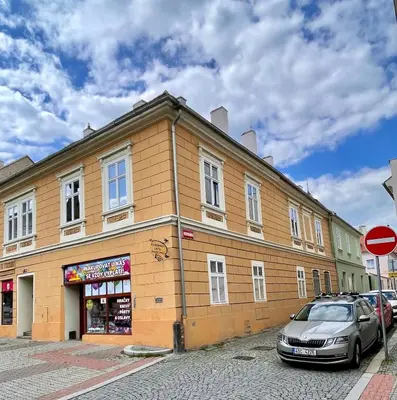 a building with a car parked in front of it at Apartmán Dominikánská in Litoměřice