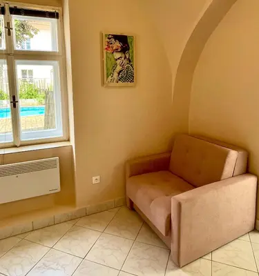 a living room with a couch and a window at Apartmán Dominikánská in Litoměřice