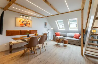a living room with a table and a couch at Classy Loft Apartment in the City Center of Prague in Prague