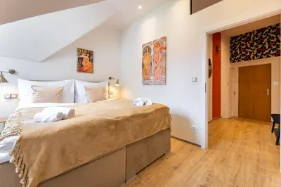 a bedroom with a large bed with towels on it at Classy Loft Apartment in the City Center of Prague in Prague