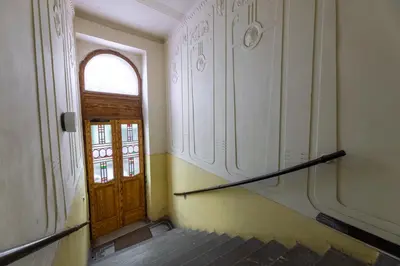 an empty hallway with a wooden door and a staircase at Classy Loft Apartment in the City Center of Prague in Prague