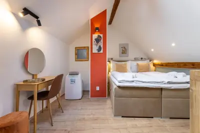 a bedroom with a bed and a table and a desk at Classy Loft Apartment in the City Center of Prague in Prague