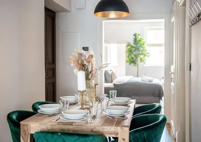 a wooden table with green chairs and a dining room at 3BR & 2,5Bath Heaven of Harmony 2 Theater VIEW in Prague