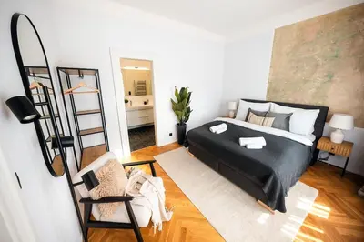 a bedroom with a bed and a chair and a mirror at 3BR & 2,5Bath Heaven of Harmony 2 Theater VIEW in Prague