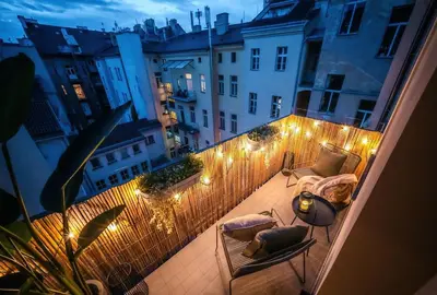 a balcony with lights and chairs and a fence at 3BR & 2,5Bath Heaven of Harmony 2 Theater VIEW in Prague