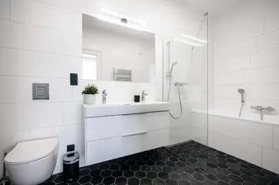 a white bathroom with a toilet and a sink at 3BR & 2,5Bath Heaven of Harmony 2 Theater VIEW in Prague