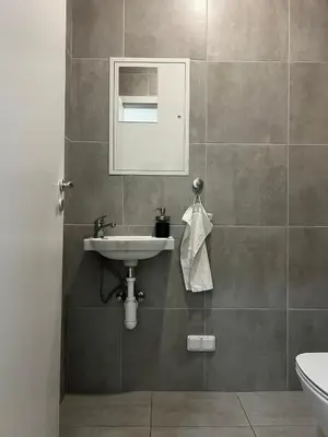 a bathroom with a sink and a mirror at Apartment A l Modern Stay with Parking in Prague