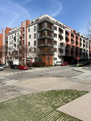an empty street with a large apartment building at Apartment A l Modern Stay with Parking in Prague