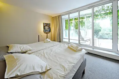 a bedroom with a large bed with two towels on it at ViDa Prostorný 220 m2 3BR Apartmán s Krbem a Zahradou, Ideální pro Rodiny in Prague