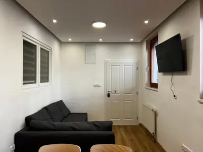 a living room with a couch and a flat screen tv at Apartment B l Modern Stay with Parking in Prague