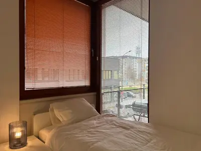 a bedroom with a bed and a window with a view at Apartment B l Modern Stay with Parking in Prague