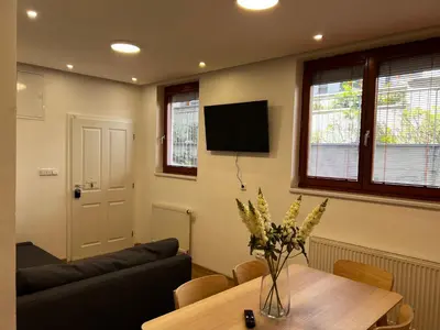 a living room with a table and a couch at Apartment B l Modern Stay with Parking in Prague