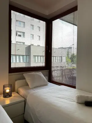 a bedroom with two beds and a window at Two Modern Apartments with Complimentary Parking in Prague