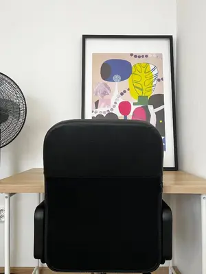 a black suitcase sitting on a table next to a picture at Two Modern Apartments with Complimentary Parking in Prague