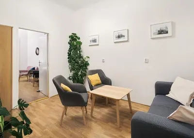 a living room with a couch and chairs and a table at Teytz Apartments in Prague