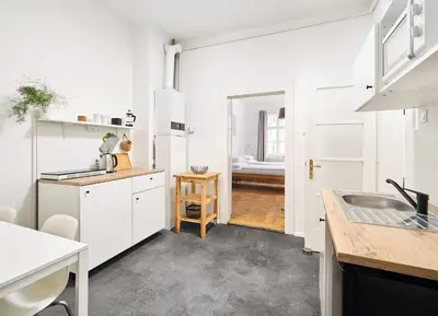 a kitchen with white cabinets and a sink at Teytz Apartments in Prague