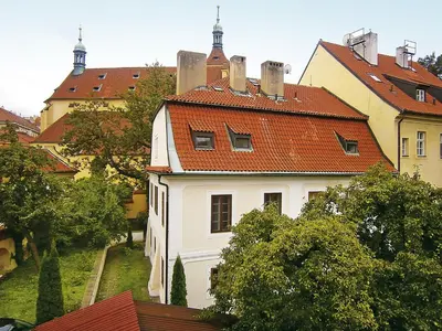a white house with a red roof at Teytz Apartments in Prague