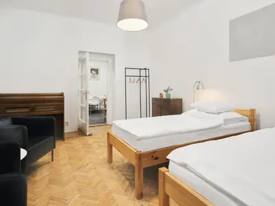 a room with two beds and a piano in it at Teytz Apartments in Prague