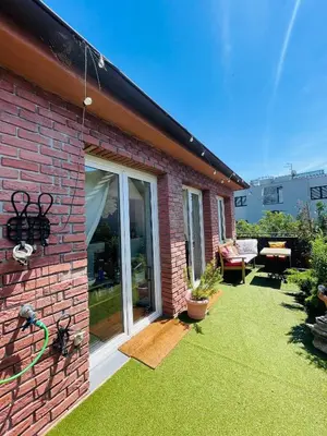 a brick house with a large sliding glass door at Flat with heart and art nearby centre of the Prague in Prague