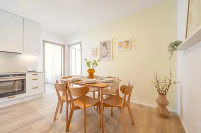 a kitchen and dining room with a table and chairs at Bright 2BR - 5th floor, Balcony, Free Parking by Gravity Prague in Prague