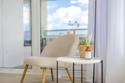 a chair and a table in front of a window at Bright 2BR - 5th floor, Balcony, Free Parking by Gravity Prague in Prague