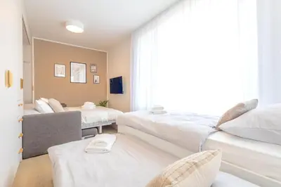 a bedroom with two beds and a window at Bright 2BR - 5th floor, Balcony, Free Parking by Gravity Prague in Prague