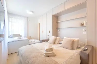 a bedroom with a large white bed with pillows at Bright 2BR - 4th floor, Balcony, Free Parking by Gravity Prague in Prague