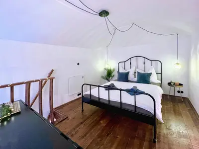 a bedroom with a bed with blue pillows at WOW MiniLoft, near Wenceslas Square, city centre, fast wifi in Prague