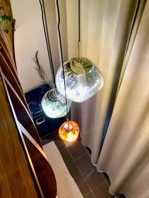 a couple of glass lights are hanging in a room at WOW MiniLoft, near Wenceslas Square, city centre, fast wifi in Prague