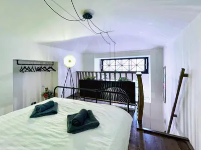 a bedroom with a bed with two blue pillows on it at WOW MiniLoft, near Wenceslas Square, city centre, fast wifi in Prague