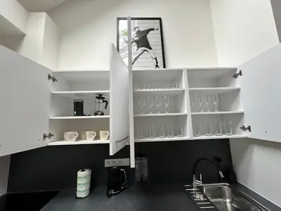 a kitchen with white cabinets and a sink at LofT apartments Prague in Prague