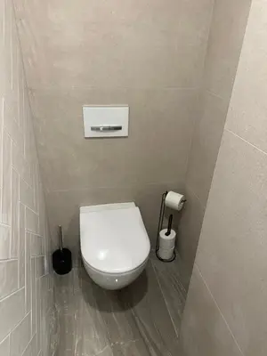 a bathroom with a white toilet in a room at LofT apartments Prague in Prague