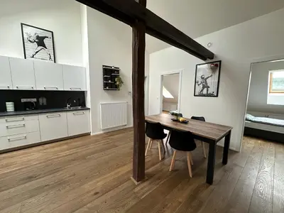 a kitchen and dining room with a table and chairs at LofT apartments Prague in Prague
