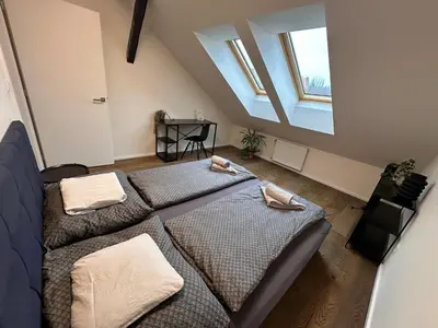 a bedroom with two beds with towels on them at LofT apartments Prague in Prague