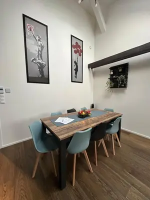 a dining room with a wooden table and chairs at LofT apartments Prague in Prague