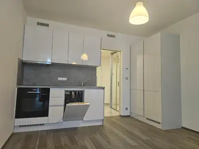 a kitchen with white cabinets and a stove top oven at NEW Apartment - O2 Arena Prague with parking in Prague
