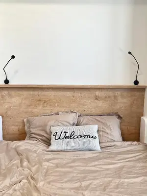 a bed with a welcome pillow on top of it at Cozy studio prague 5 in Prague