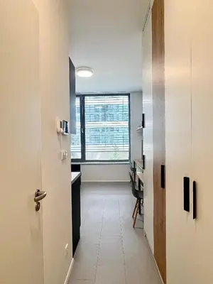 a hallway with a room with a desk and a window at Cozy studio prague 5 in Prague