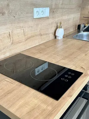 a kitchen with a counter top with a stove at Cozy studio prague 5 in Prague