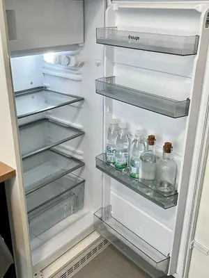 an open refrigerator filled with lots of water bottles at Cozy studio prague 5 in Prague