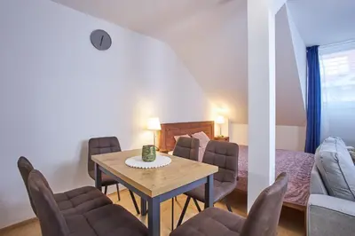 a room with a table and chairs and a bed at Wenceslas Square Residence in Prague