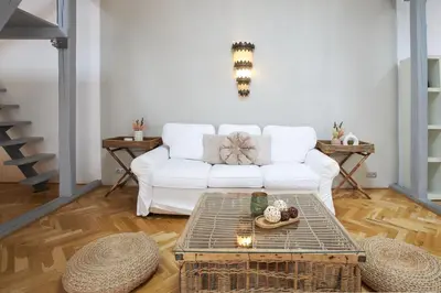 a living room with a white couch and a table at Wenceslas Square Residence in Prague