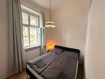 a bedroom with a bed and a window at Luxury flat in Prague city center SUPERHOST - 5 STAR in Prague