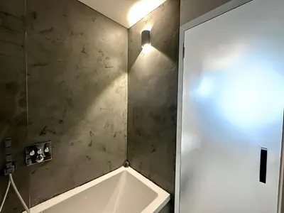 a bathroom with a bath tub next to a door at Luxury flat in Prague city center SUPERHOST - 5 STAR in Prague