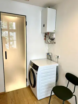 a laundry room with a washing machine and a door at Luxury flat in Prague city center SUPERHOST - 5 STAR in Prague