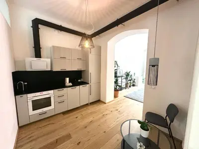 a kitchen with white cabinets and a large window at Luxury flat in Prague city center SUPERHOST - 5 STAR in Prague